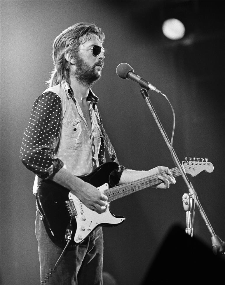 Eric Clapton playing electric guitar at the Cow Palace during his 1974 comeback tour.