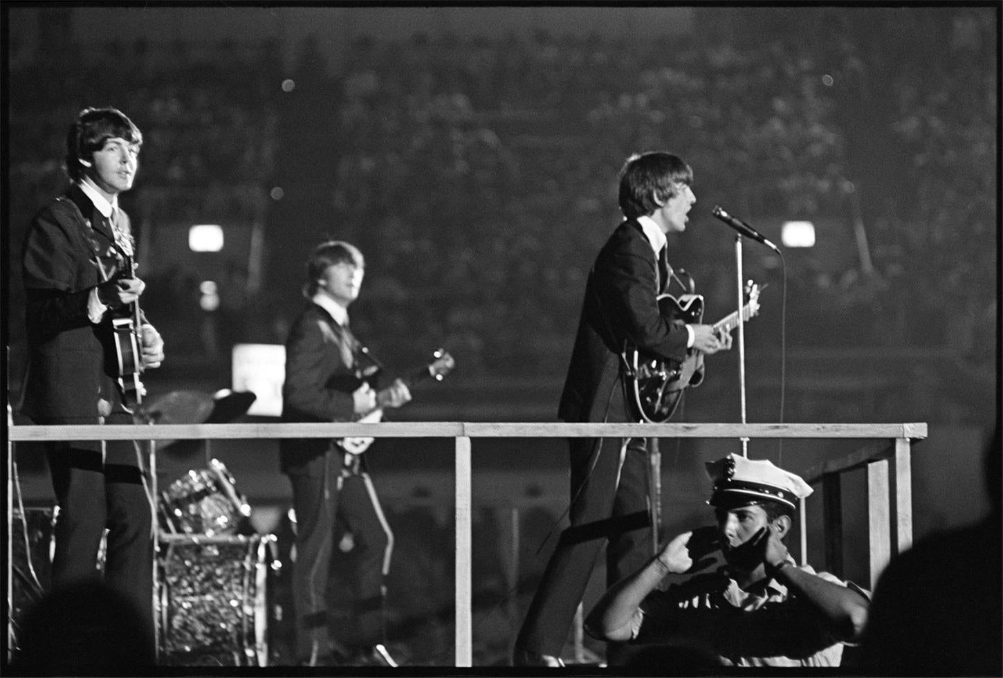 The Beatles, on stage with cop, 1964 - Morrison Hotel Gallery